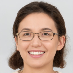 Joyful white young-adult female with medium  brown hair and green eyes