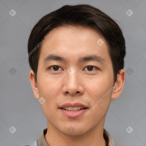 Joyful asian young-adult male with short  brown hair and brown eyes