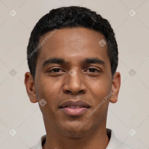 Joyful black young-adult male with short  black hair and brown eyes
