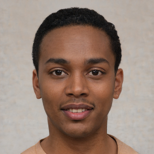 Joyful black young-adult male with short  black hair and brown eyes
