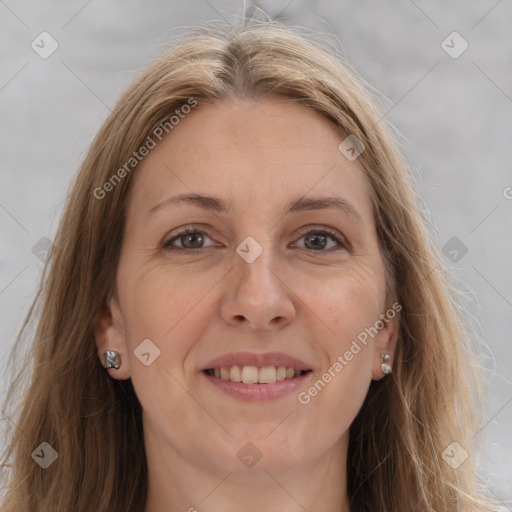 Joyful white adult female with long  brown hair and grey eyes