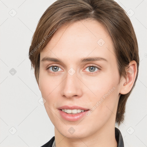 Joyful white young-adult female with medium  brown hair and grey eyes