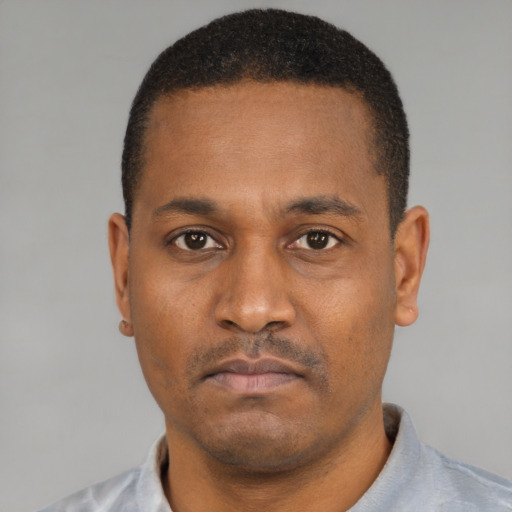 Neutral latino adult male with short  black hair and brown eyes