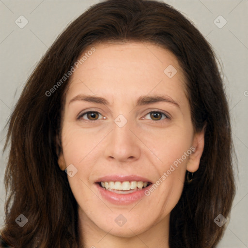 Joyful white adult female with long  brown hair and brown eyes