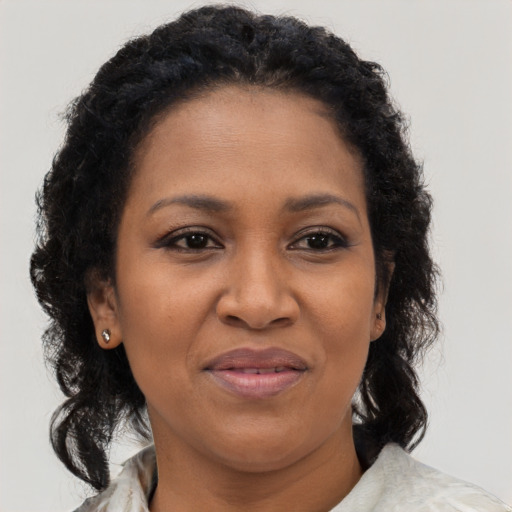 Joyful black adult female with medium  brown hair and brown eyes