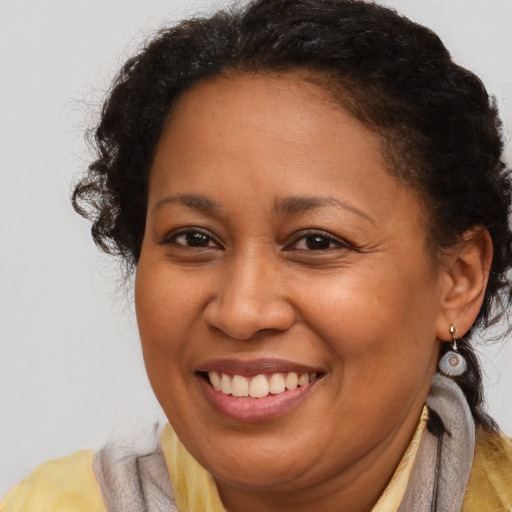 Joyful latino adult female with short  brown hair and brown eyes