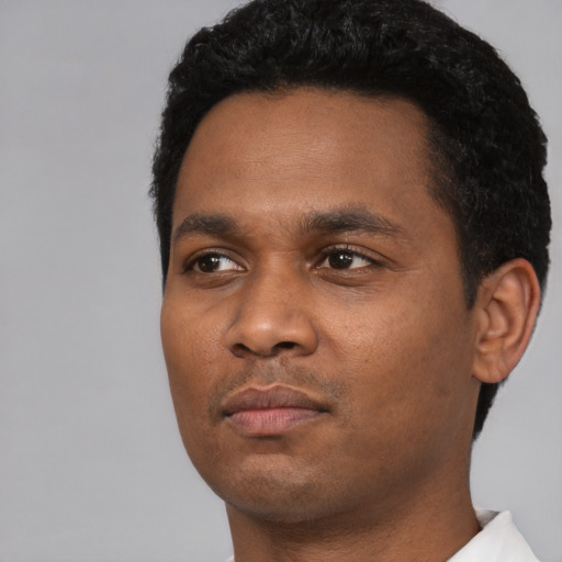 Neutral black young-adult male with short  black hair and brown eyes