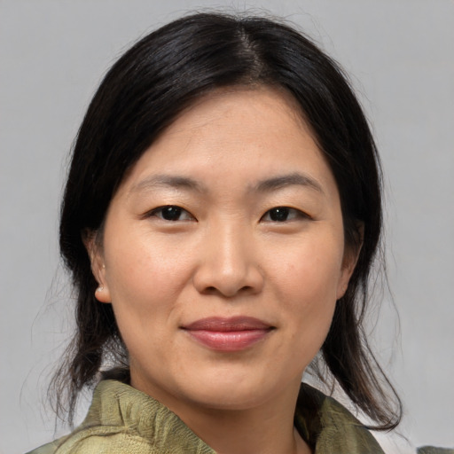 Joyful asian young-adult female with medium  black hair and brown eyes