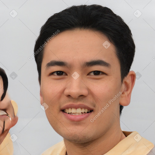 Joyful asian young-adult male with short  black hair and brown eyes