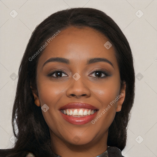 Joyful black young-adult female with long  black hair and brown eyes