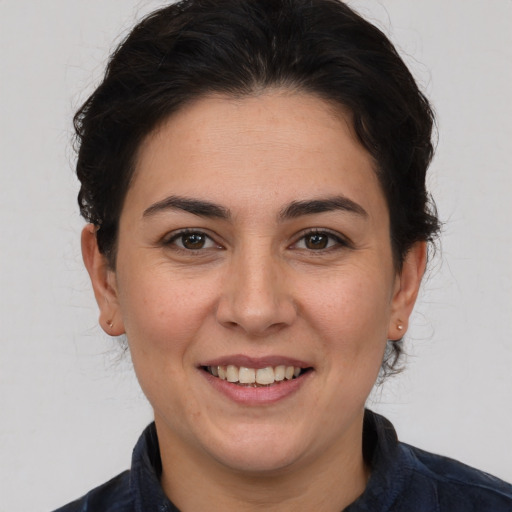 Joyful white adult female with medium  brown hair and brown eyes