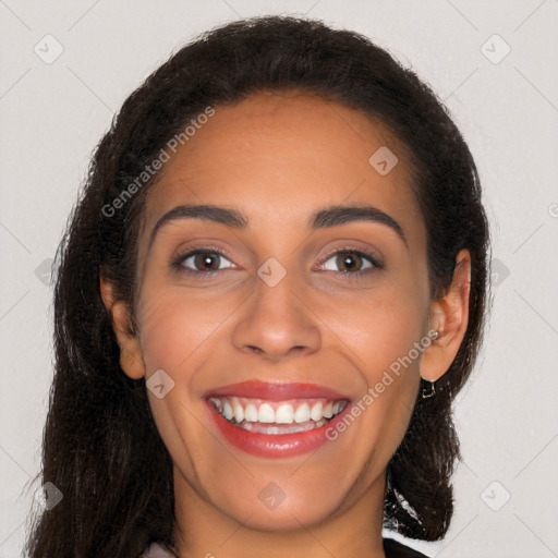 Joyful latino young-adult female with long  brown hair and brown eyes