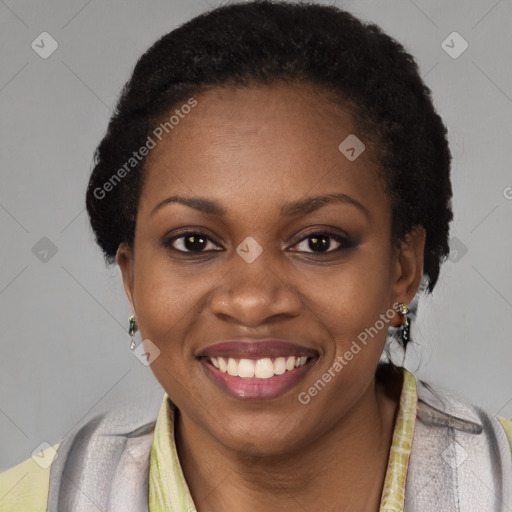 Joyful black young-adult female with short  black hair and brown eyes