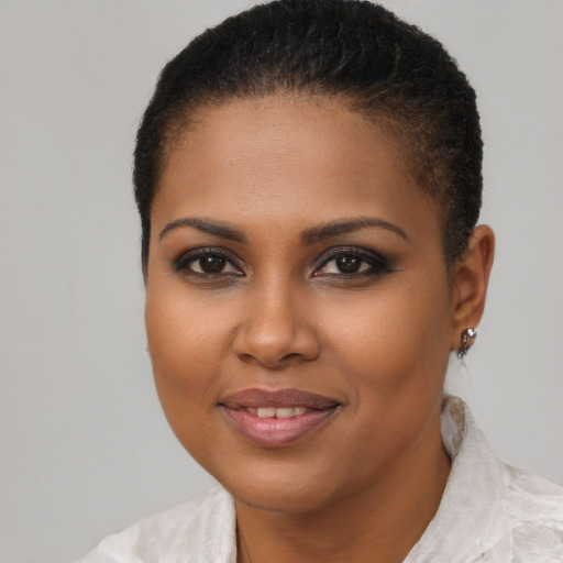 Joyful black young-adult female with short  brown hair and brown eyes