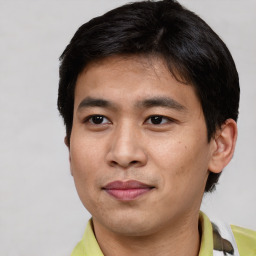 Joyful asian young-adult male with short  brown hair and brown eyes