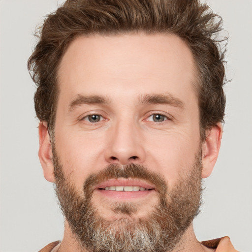 Joyful white adult male with short  brown hair and brown eyes