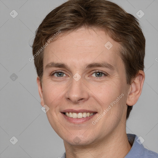 Joyful white adult male with short  brown hair and grey eyes