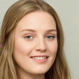 Joyful white young-adult female with long  brown hair and green eyes