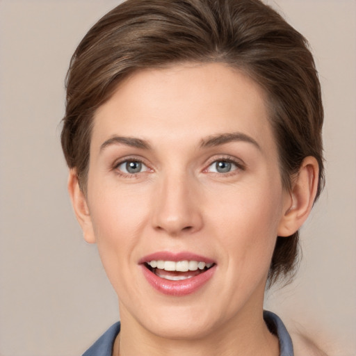 Joyful white young-adult female with medium  brown hair and grey eyes