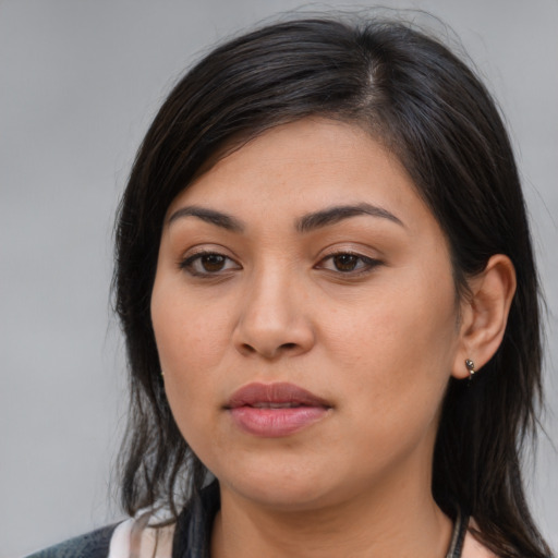 Joyful latino young-adult female with medium  brown hair and brown eyes