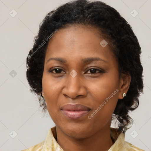 Joyful black adult female with medium  brown hair and brown eyes