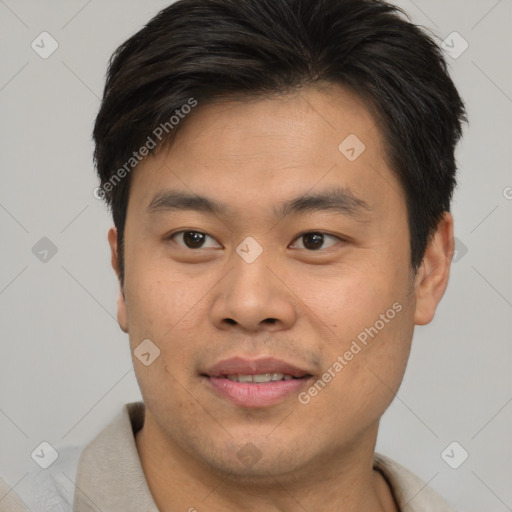 Joyful asian young-adult male with short  brown hair and brown eyes