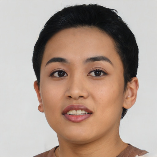 Joyful asian young-adult female with short  black hair and brown eyes