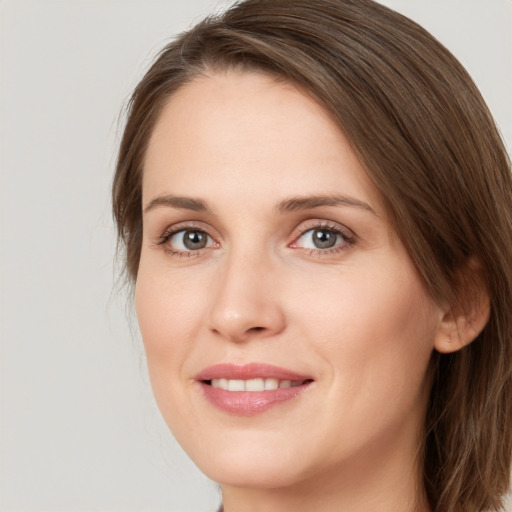 Joyful white young-adult female with medium  brown hair and green eyes