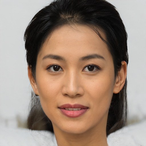 Joyful asian young-adult female with medium  brown hair and brown eyes