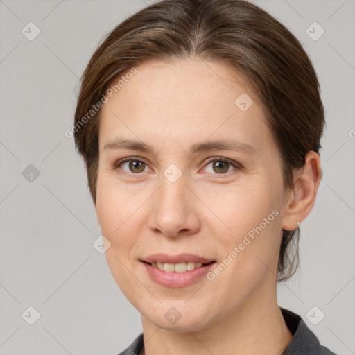 Joyful white young-adult female with medium  brown hair and grey eyes