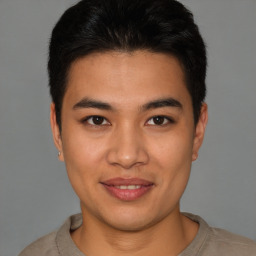 Joyful latino young-adult male with short  brown hair and brown eyes