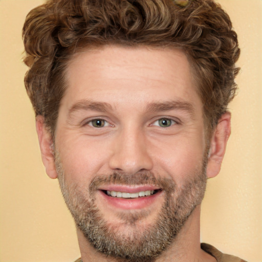 Joyful white adult male with short  brown hair and green eyes