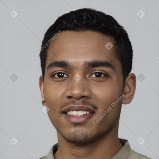 Joyful black young-adult male with short  black hair and brown eyes