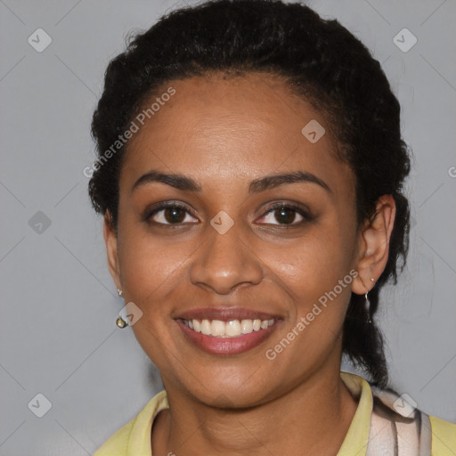 Joyful black young-adult female with short  black hair and brown eyes