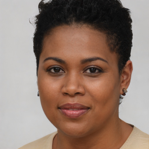 Joyful black young-adult female with short  brown hair and brown eyes
