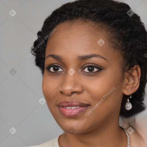 Joyful black young-adult female with long  black hair and brown eyes