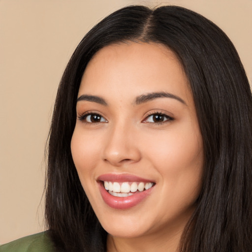 Joyful latino young-adult female with long  black hair and brown eyes