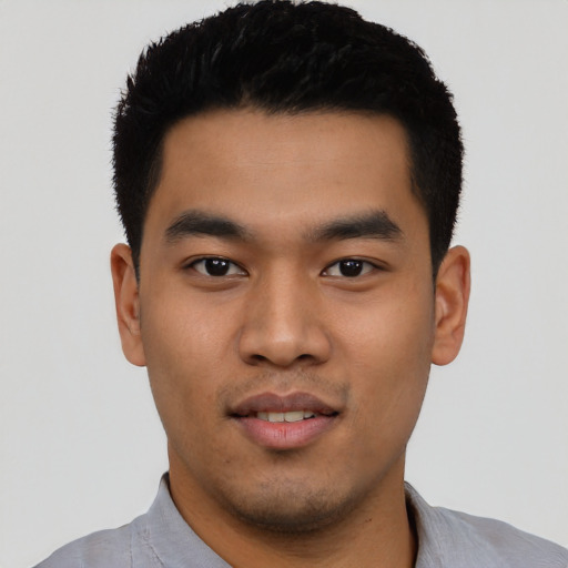 Joyful asian young-adult male with short  black hair and brown eyes