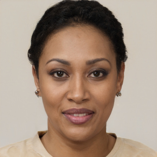 Joyful black young-adult female with short  black hair and brown eyes