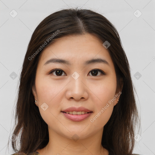 Joyful asian young-adult female with long  brown hair and brown eyes