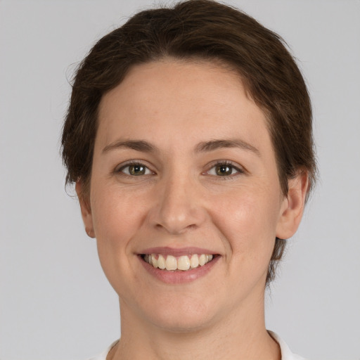 Joyful white adult female with short  brown hair and grey eyes