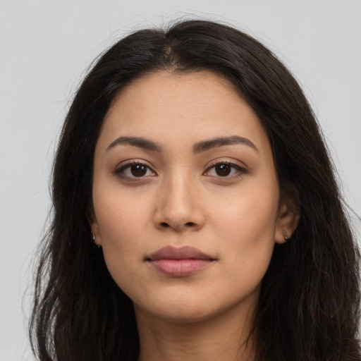 Neutral latino young-adult female with long  brown hair and brown eyes