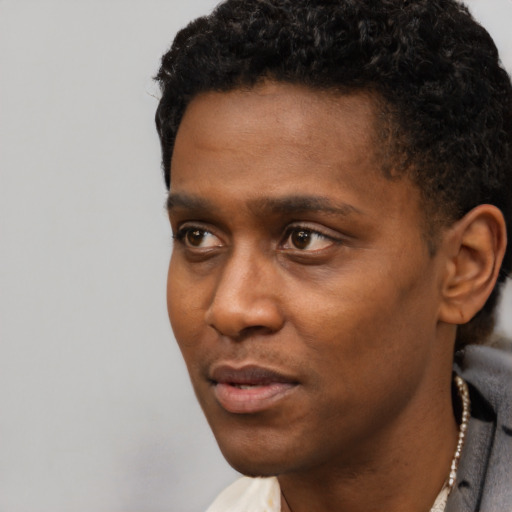 Neutral black young-adult male with short  black hair and brown eyes