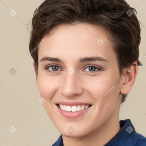 Joyful white young-adult female with short  brown hair and grey eyes