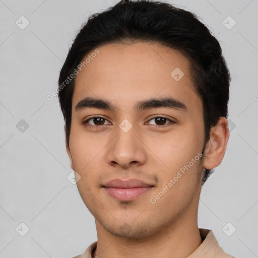 Joyful latino young-adult male with short  black hair and brown eyes