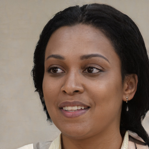 Joyful black young-adult female with medium  black hair and brown eyes