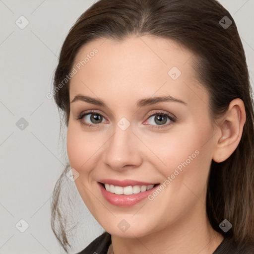 Joyful white young-adult female with medium  brown hair and grey eyes