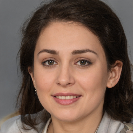 Joyful white young-adult female with medium  brown hair and brown eyes