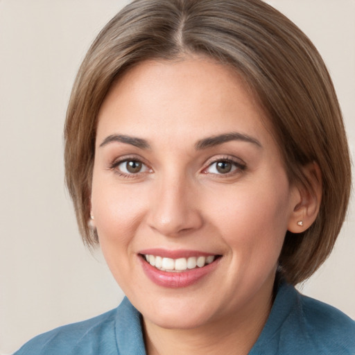 Joyful white young-adult female with medium  brown hair and grey eyes