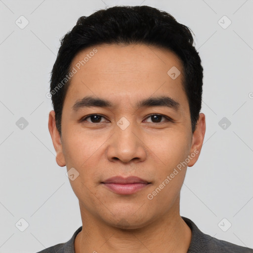 Joyful asian young-adult male with short  black hair and brown eyes